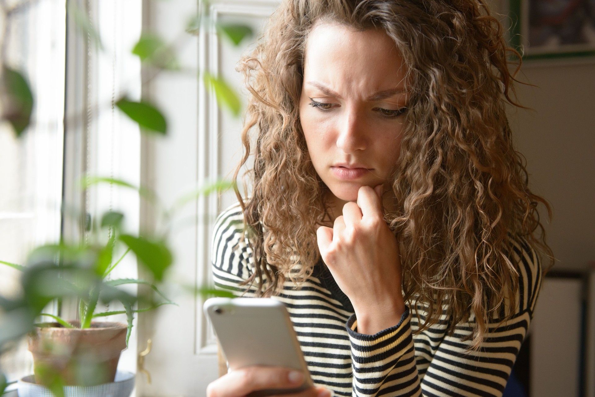 Stressed Looking at Smartphone Screen